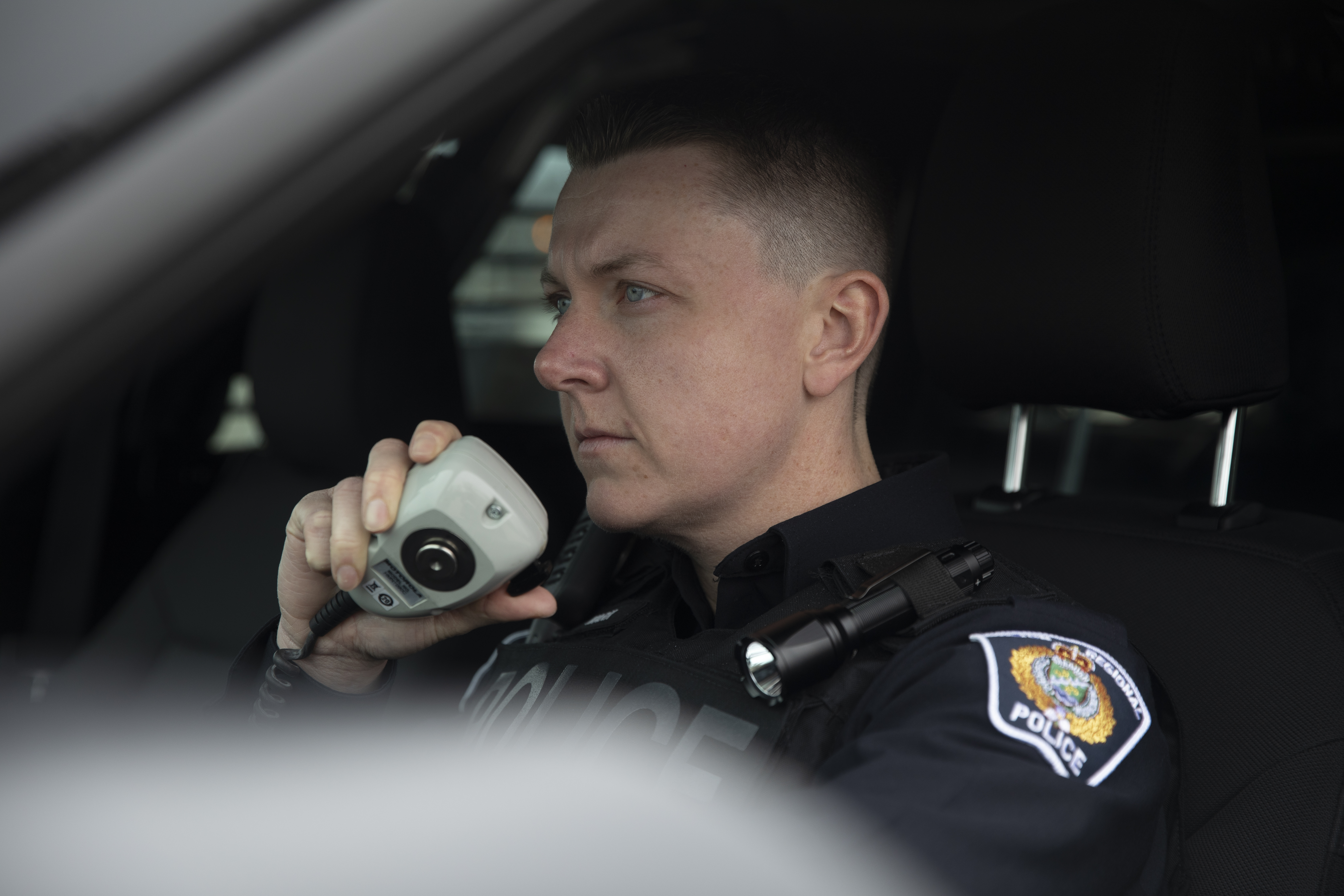 Officer in her cruiser on the radio