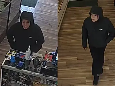Female robbery suspect dressed in all black clothing